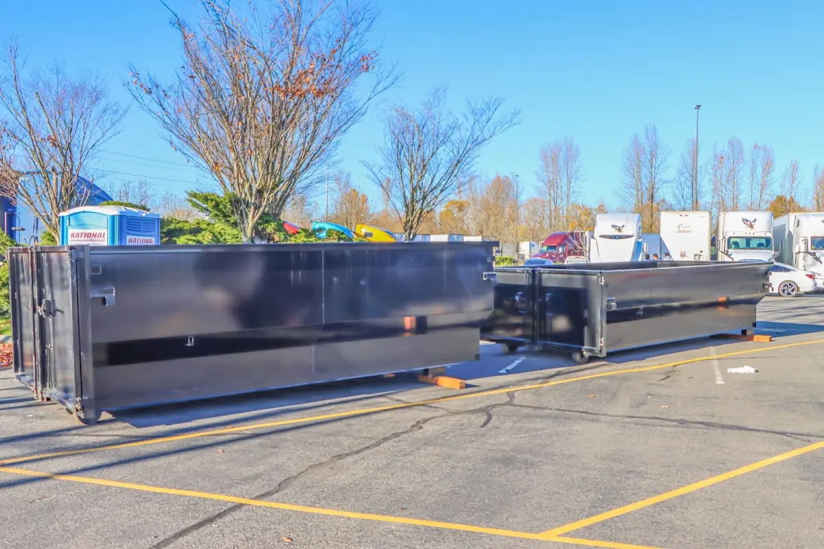 Professional dumpster rental service with roll-off container on residential driveway in Wilmer